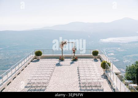 Idyllic seaside ceremony setting featuring stylish arrangements and scenic surroundings Stock Photo