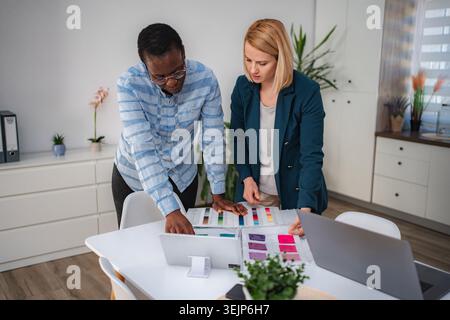 Diverse designers collaborating on color swatches for new project Stock Photo