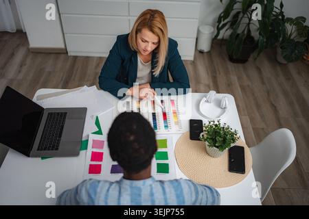 Fashion designers collaborating on color swatches selecting materials Stock Photo