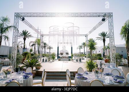 Elegant openair celebration environment. Stylish daytime outdoor function with decorative lighting Stock Photo
