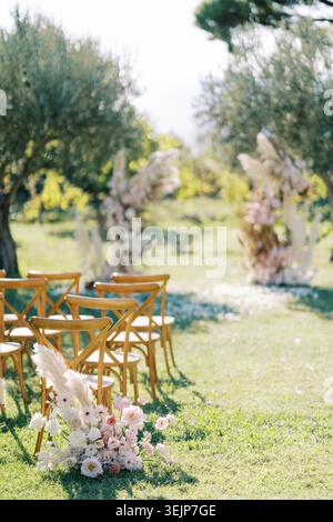 Al fresco celebration. Sunny outdoor wedding setup. Rustic ceremony with natural floral arrangements Stock Photo