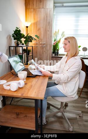 Engaging work session in a bright home office filled with greenery Stock Photo