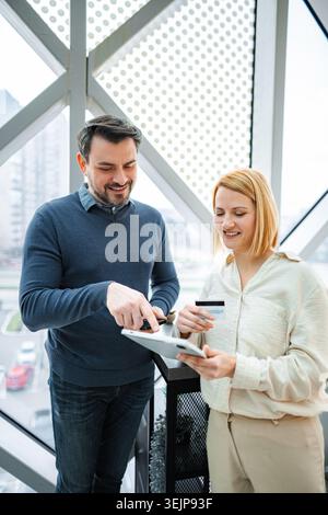 Business partners making online payment using tablet and credit card Stock Photo