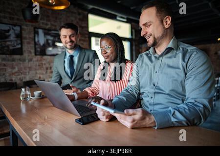 Business people collaborating on project using laptop and digital tablet Stock Photo