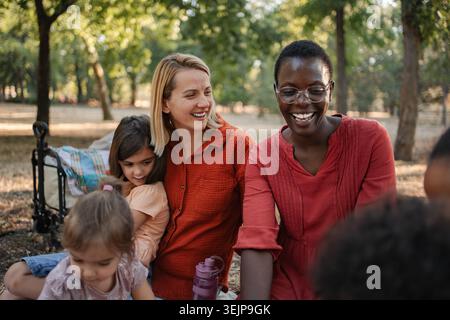 Teachers enjoying a day at the park with their students Stock Photo