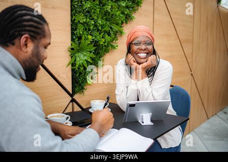 Diverse business professionals having a coffee shop meeting Stock Photo