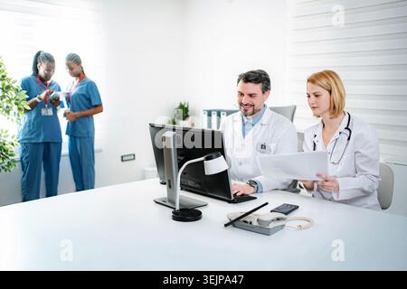 Medical professionals collaborating in modern clinic office Stock Photo