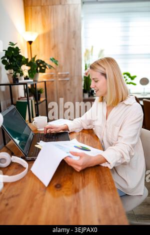 Working woman engaged in preparation at a cozy home office environment Stock Photo
