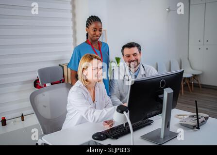 Medical professionals collaborating on computer in modern office Stock Photo