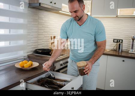 Man preparing coffee in modern kitchen at home Stock Photo