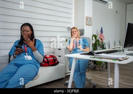 Exhausted nurses taking a short break during long hospital shift Stock Photo