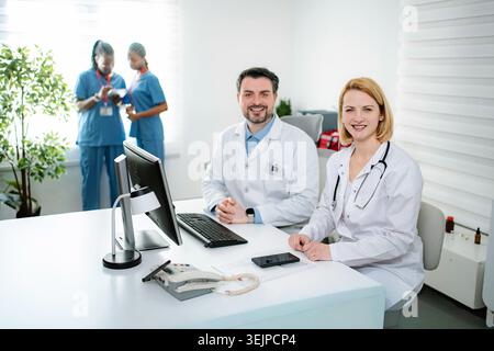 Medical professionals smiling in modern clinic office Stock Photo