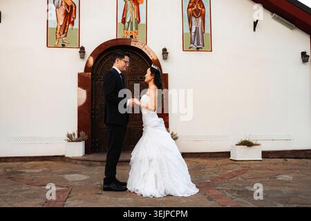 Bride and groom holding hands, celebrating their wedding day Stock Photo