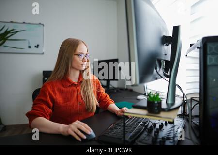 Engaging in focused work at a modern home office environment Stock Photo