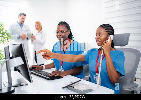 Medical professionals working in hospital reception area Stock Photo