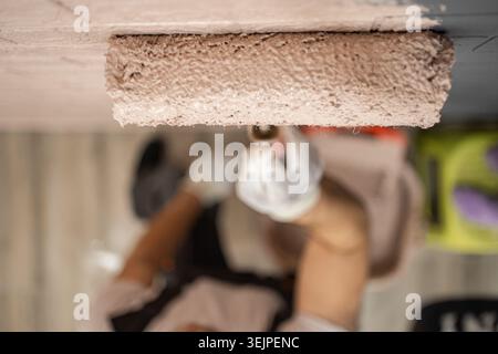 Roller with paint on the wall Stock Photo