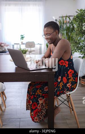 Young woman using her laptop, working from home Stock Photo