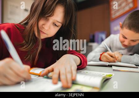 Two elementary students learning together at language school Stock Photo