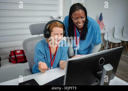 Two female nurses providing support and assistance in a medical call center Stock Photo