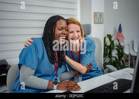Diverse medical staff colleagues laughing with unity and success Stock Photo