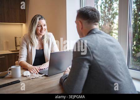 Man and Woman Working on Laptop at Table Stock Photo
