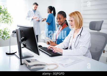 Medical professionals working together on computer in clinic Stock Photo