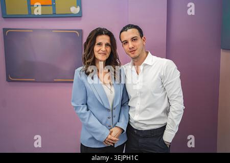 Teacher with male student in classroom Stock Photo