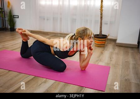 Practicing advanced yoga poses in a serene indoor setting Stock Photo