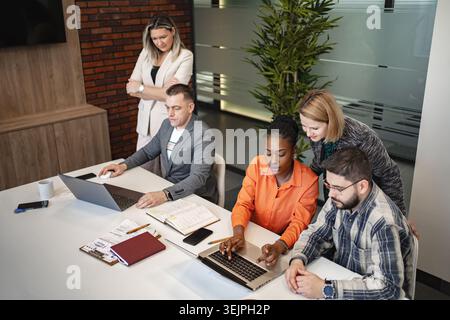 Team of Professionals Collaborating on Laptops Stock Photo