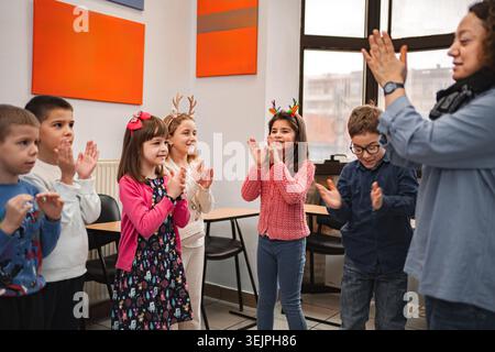Teacher and elementary students at language school class Stock Photo