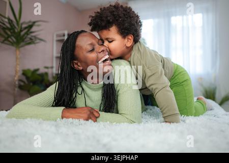 Happy African American mother laughing with son Stock Photo