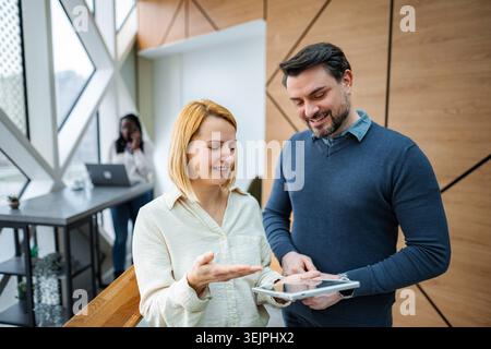 Business colleagues collaborating using digital tablet in office Stock Photo