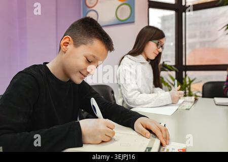 Two elementary students learning together at language school Stock Photo