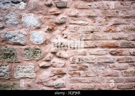 Close view of a textured stone and brick wall in a city Stock Photo