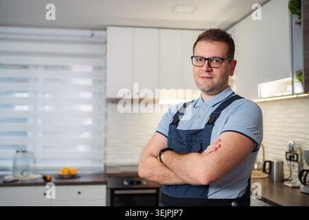 Man technician in uniform standing with crossed arms Stock Photo