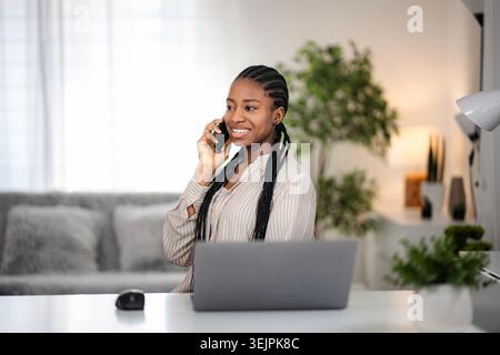 Young black woman telecommunicating and working from home Stock Photo