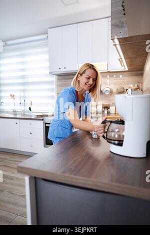 Female medical worker making coffee Stock Photo