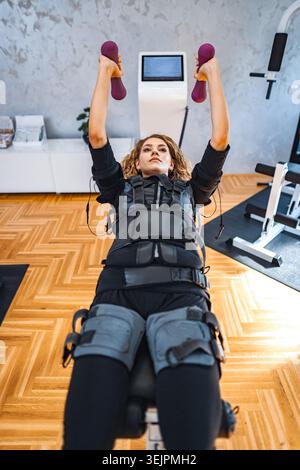 Empowered strength training session with muscle stimulation Stock Photo