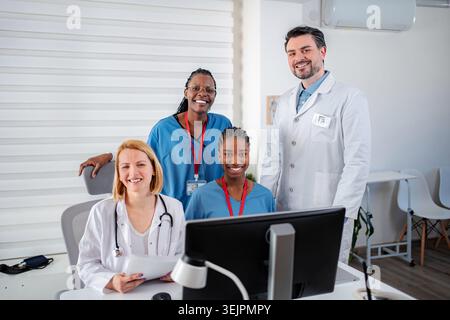 Diverse medical team smiling in modern clinic office Stock Photo