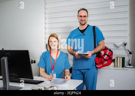 Medical team members smiling at clinic office Stock Photo