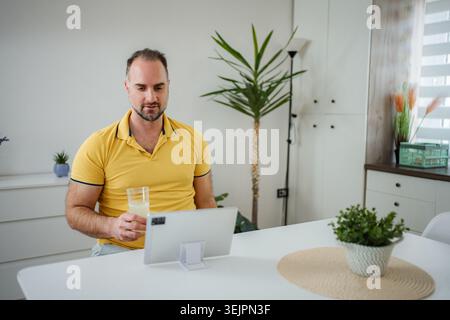 Man learning working from home using digital tablet Stock Photo