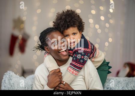 Mother and son embracing during festive Christmas celebration Stock Photo