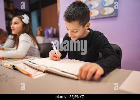 Two elementary students learning together at language school Stock Photo