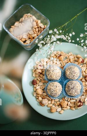 Healthy energy balls with peanuts and hazelnuts on plate Stock Photo