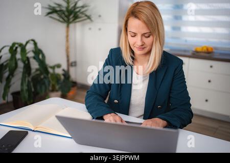 Woman working from home using laptop computer Stock Photo
