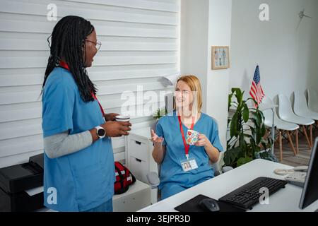 Healthcare workers enjoying coffee break discussing work Stock Photo