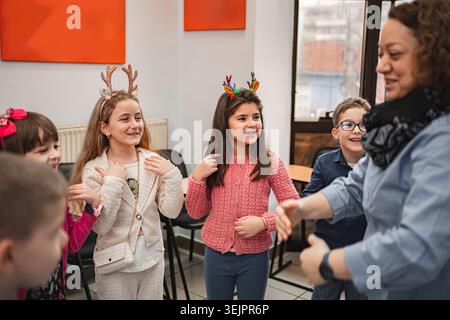 Teacher and elementary students at language school class Stock Photo