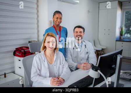 Diverse medical team collaborating in clinic office Stock Photo