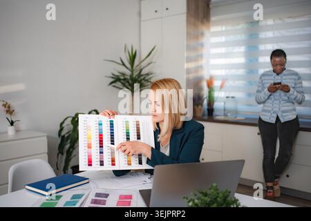 Creative fashion designers choosing colors for new collection Stock Photo