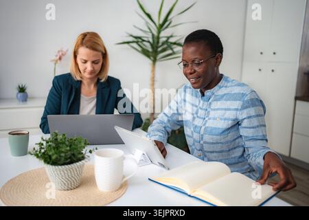 Diverse women working remotely from home office Stock Photo